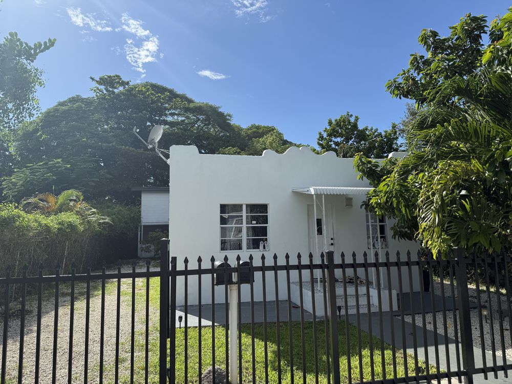 The same Buena Vista triplex after a full gut renovation, refinished in flat white stucco