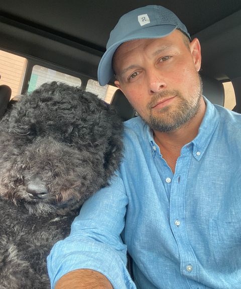 Chris Johnson of Johnson Buys in his truck with his dog