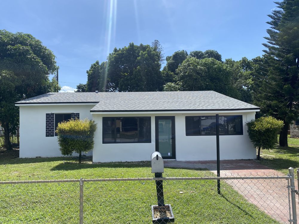 The same West Little River house after a full gut renovation, with a new roof, impact windows and new flat stucco